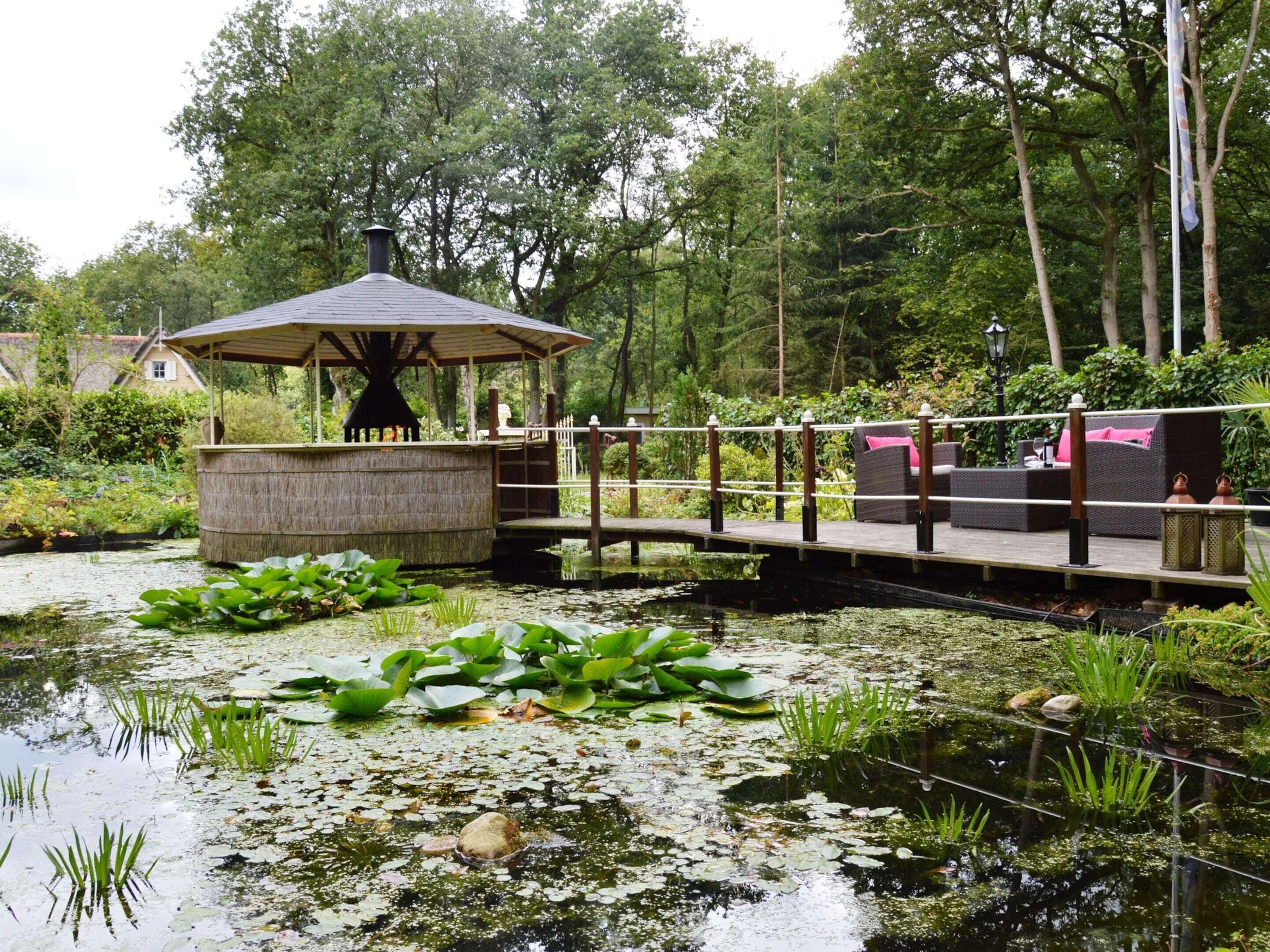 A Detached Bungalow With Outdoor Fireplace, Covered Terrace and Pond in a Forest Plot